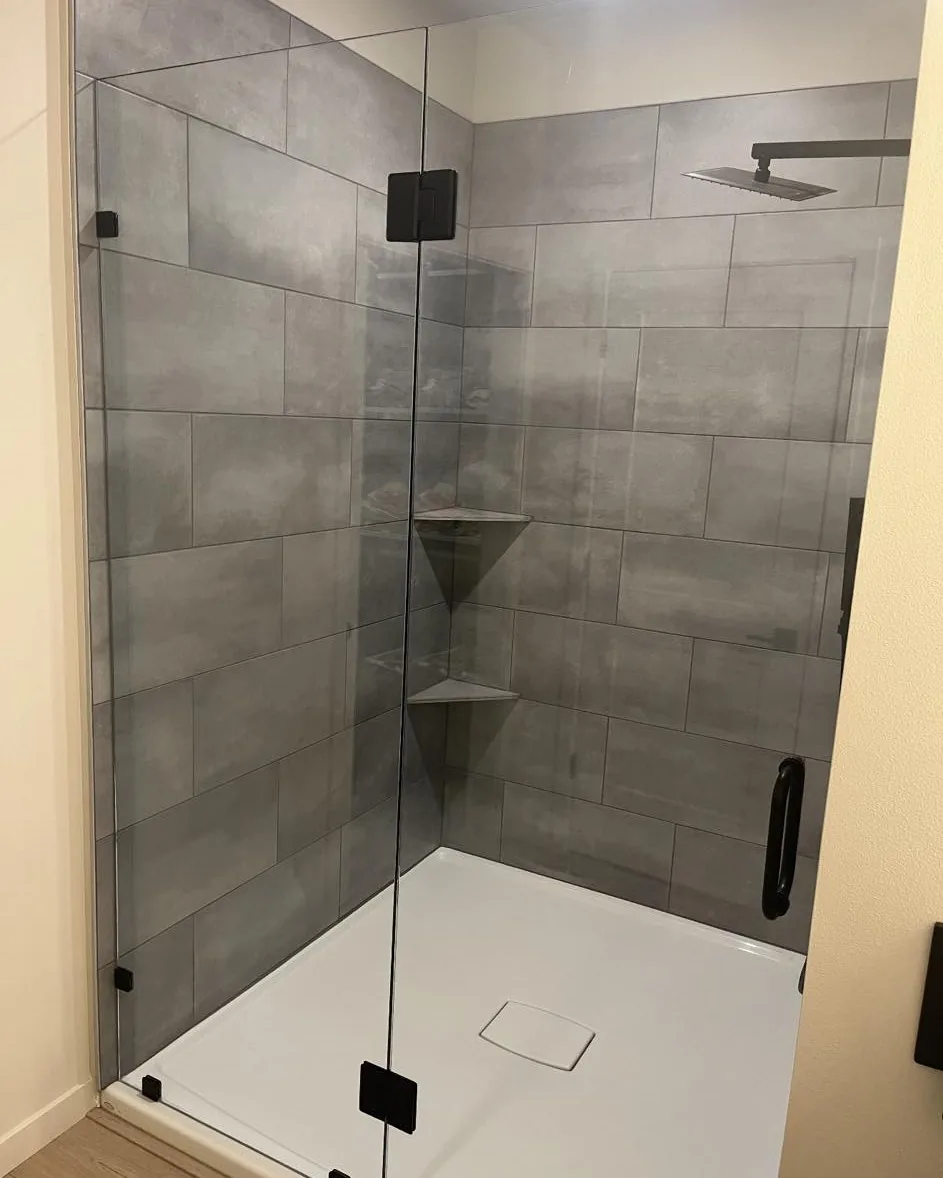 Frameless shower door replacement with gray tile
