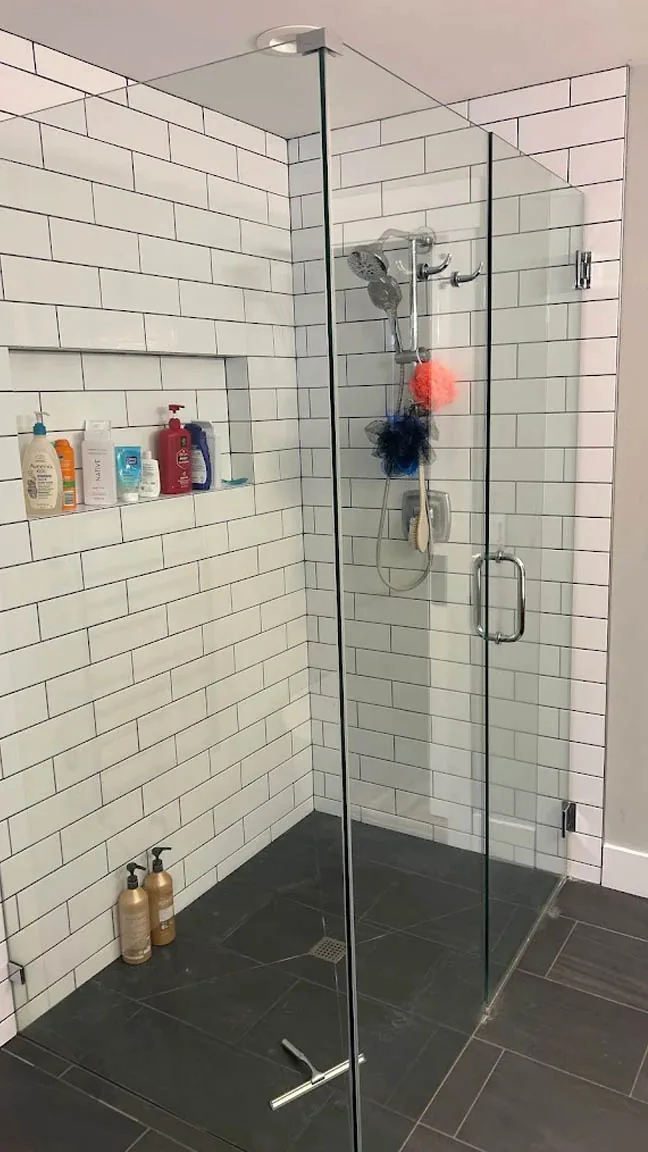 Frameless walk-in shower replacement with subway tile